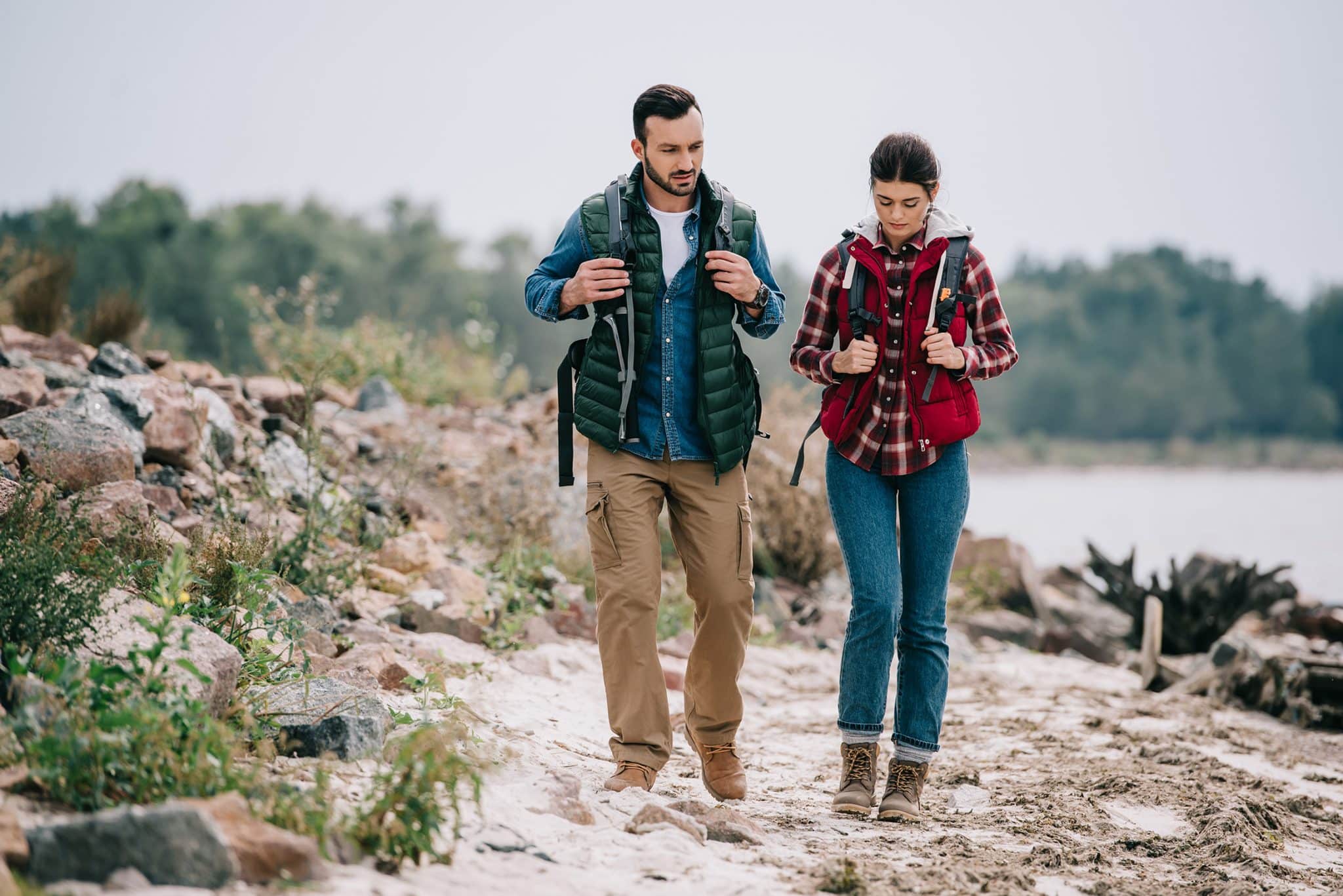 hikers-with-backpacks-walking-on-sandy-beach-toget-2022-12-16-16-44-22-utc