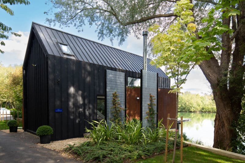Scandinavian Tiny Home in The Cotswolds available to rent short term with a glass front that looks onto the lake
